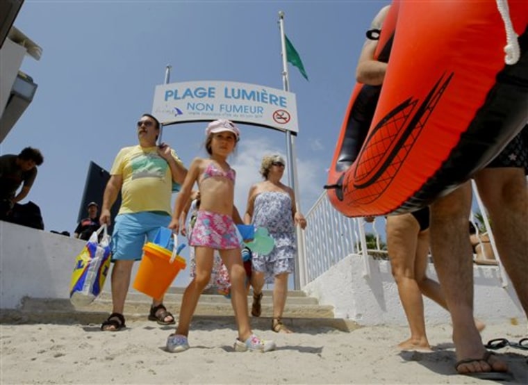 Beachgoers arrive Aug. 2 at La Ciotat beach, where smoking is banned, near Marseille in southern France. 